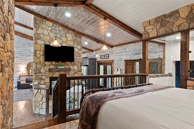 180 Black Jack Trl, Hochatown, OK 74728 - bedroom with a stone fireplace and wood finished floors
