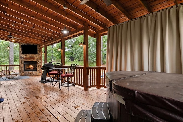 180 Black Jack Trl, Hochatown, OK 74728 - deck featuring a hot tub and an outdoor stone fireplace