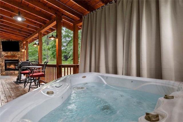 180 Black Jack Trl, Hochatown, OK 74728 - misc room featuring a jacuzzi, lofted ceiling, an outdoor stone fireplace, wood-type flooring, and wood ceiling