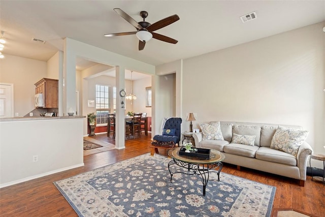 2321 NW 162nd Ter, Edmond, OK 73013 - living room featuring a ceiling fan, wood finished floors, and a chandelier