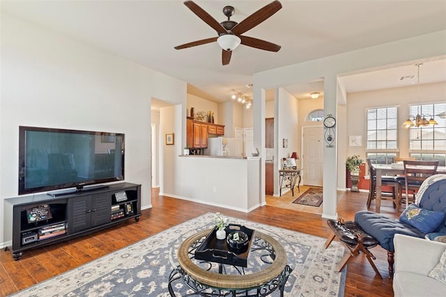 2321 NW 162nd Ter, Edmond, OK 73013 - living area featuring a chandelier, a ceiling fan, and wood finished floors