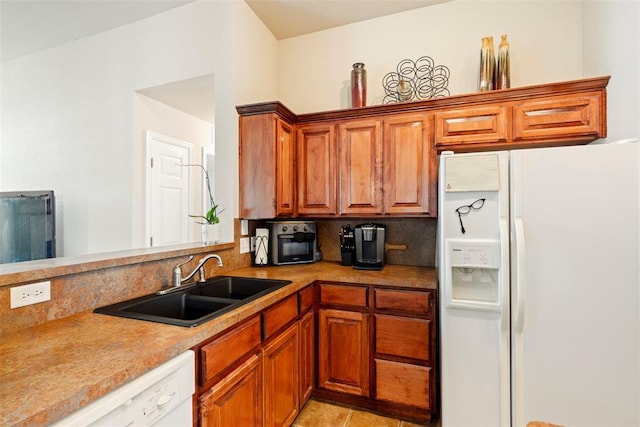 2321 NW 162nd Ter, Edmond, OK 73013 - kitchen featuring white appliances, brown cabinetry, light countertops, and light tile patterned floors