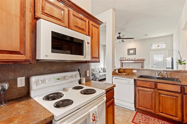 2321 NW 162nd Ter, Edmond, OK 73013 - kitchen with white appliances, ceiling fan, brown cabinetry, decorative backsplash, and light tile patterned floors
