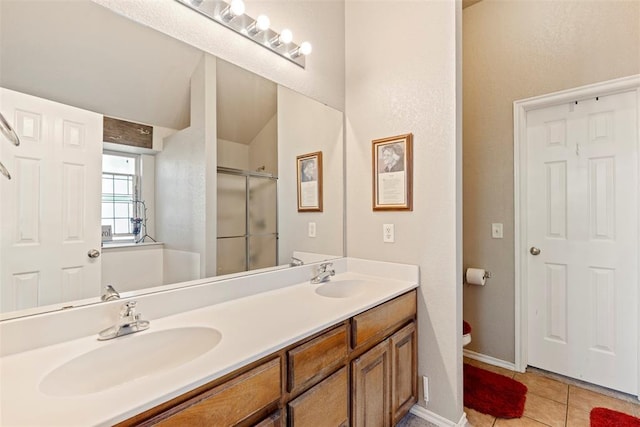 2321 NW 162nd Ter, Edmond, OK 73013 - full bathroom featuring double vanity, tile patterned flooring, and a shower