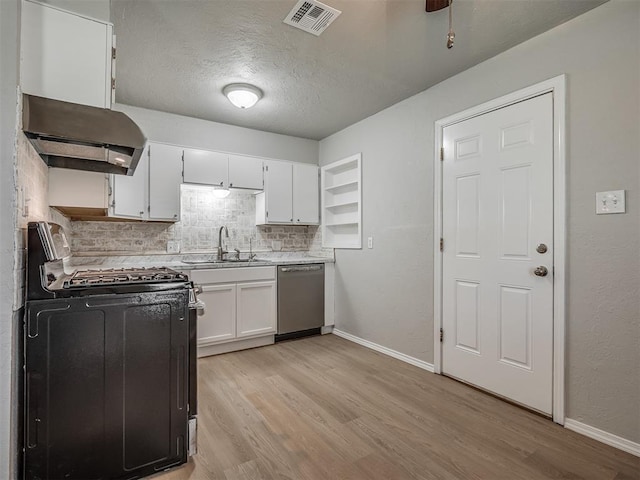 118 W Marshall Dr, Oklahoma City, OK 73110 - kitchen featuring gas range, stainless steel dishwasher, range hood, light wood finished floors, and a textured ceiling