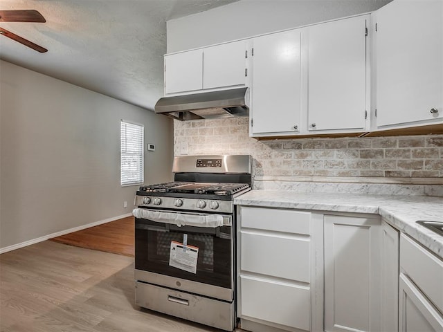 118 W Marshall Dr, Oklahoma City, OK 73110 - kitchen featuring stainless steel gas range, extractor fan, a ceiling fan, decorative backsplash, and a textured ceiling