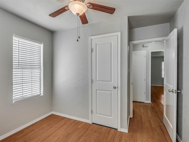 118 W Marshall Dr, Oklahoma City, OK 73110 - unfurnished bedroom with light wood-style floors, a ceiling fan, and a textured wall
