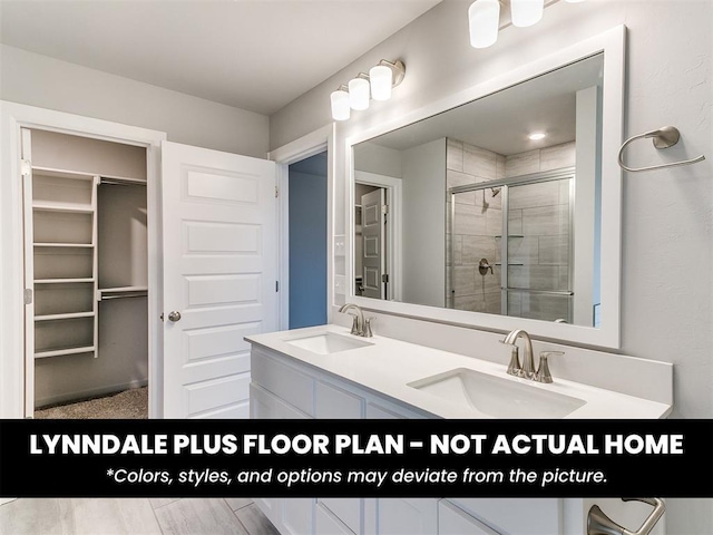 1004 Redwood Creek Dr, Yukon, OK 73099 - bathroom featuring a spacious closet, a shower stall, and double vanity