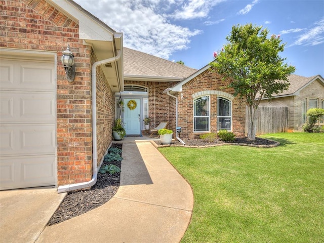 749 Dana Dr, Yukon, OK 73099 - doorway to property with brick siding, a garage, and a shingled roof