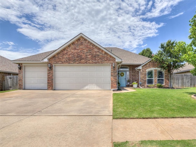 749 Dana Dr, Yukon, OK 73099 - view of front facade with brick siding, driveway, a garage, and a shingled roof