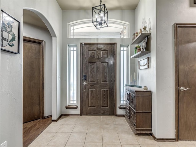 749 Dana Dr, Yukon, OK 73099 - entryway featuring arched walkways, a chandelier, and light tile patterned floors