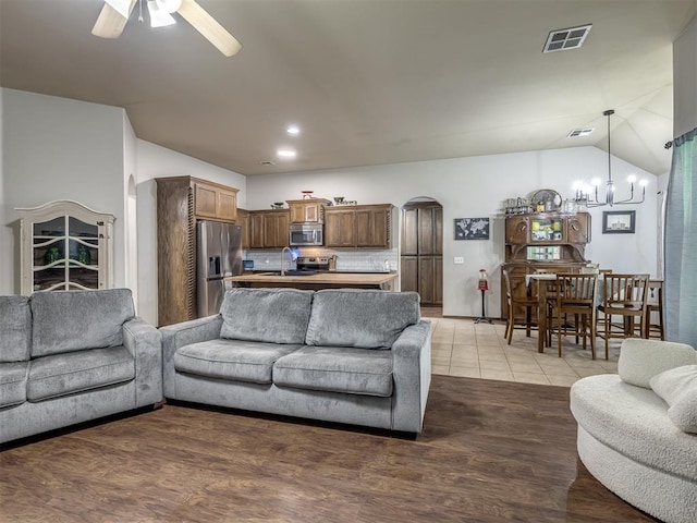 749 Dana Dr, Yukon, OK 73099 - living room featuring arched walkways, a ceiling fan, and lofted ceiling