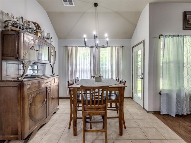 749 Dana Dr, Yukon, OK 73099 - dining area featuring lofted ceiling, a chandelier, and light tile patterned flooring