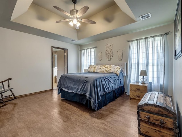 749 Dana Dr, Yukon, OK 73099 - bedroom featuring wood finished floors, a raised ceiling, and ceiling fan