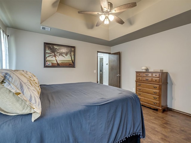749 Dana Dr, Yukon, OK 73099 - bedroom featuring a raised ceiling, wood finished floors, and ceiling fan