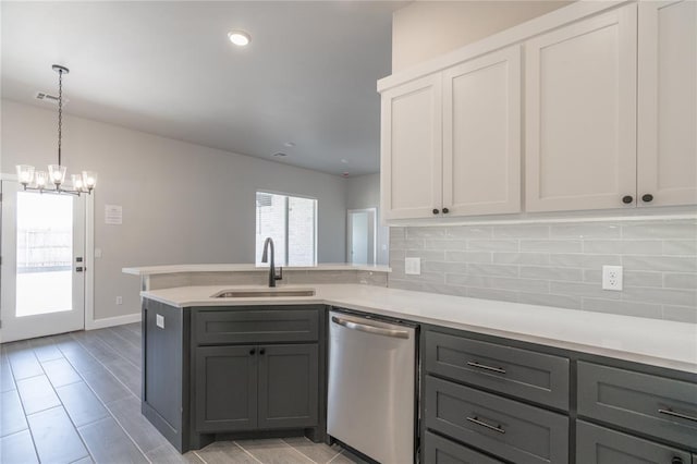 1224 Colonial Ave, Tuttle, OK 73089 - kitchen featuring stainless steel dishwasher, gray cabinetry, backsplash, and light countertops