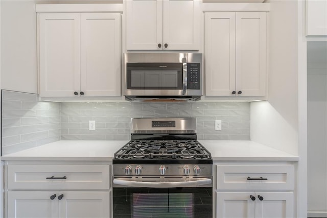1224 Colonial Ave, Tuttle, OK 73089 - kitchen featuring appliances with stainless steel finishes, light countertops, tasteful backsplash, and white cabinetry