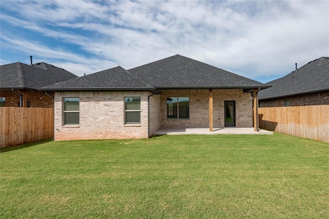 1224 Colonial Ave, Tuttle, OK 73089 - rear view of house featuring a patio area, a shingled roof, brick siding, and a fenced backyard