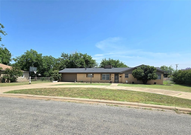 2015 Willard Dr, Altus, OK 73521 - ranch-style home with concrete driveway, a front lawn, an attached garage, and a chimney