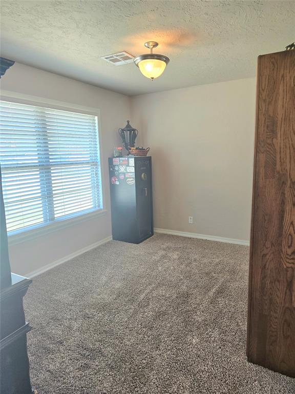2015 Willard Dr, Altus, OK 73521 - unfurnished room with a textured ceiling and carpet