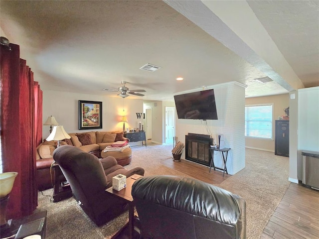 2015 Willard Dr, Altus, OK 73521 - living area featuring light wood-style floors, a fireplace, recessed lighting, ceiling fan, and a textured ceiling