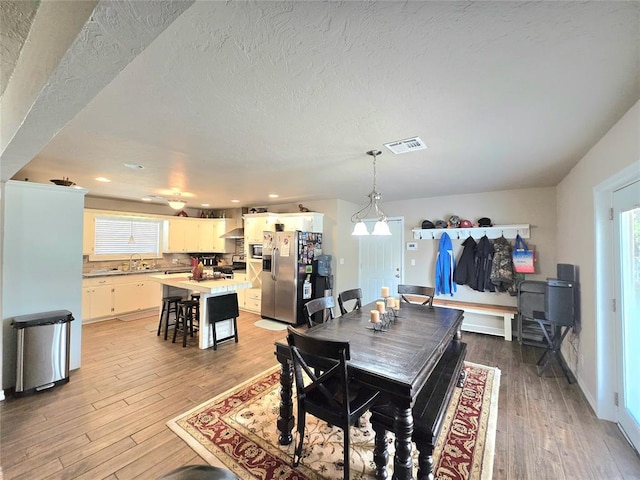 2015 Willard Dr, Altus, OK 73521 - dining area with light wood-style flooring, healthy amount of natural light, recessed lighting, and a textured ceiling