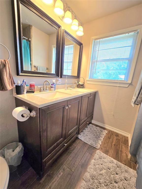 2015 Willard Dr, Altus, OK 73521 - bathroom featuring wood finished floors and double vanity