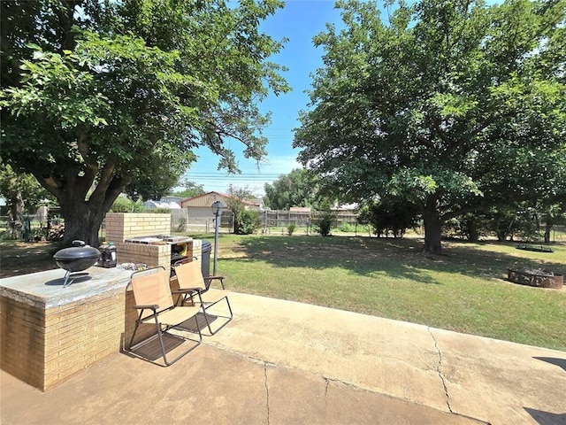 2015 Willard Dr, Altus, OK 73521 - fenced backyard with a patio area and an outdoor fire pit