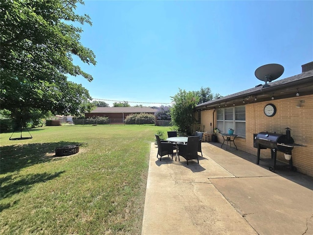 2015 Willard Dr, Altus, OK 73521 - view of yard featuring a fire pit, a patio area, and outdoor dining space