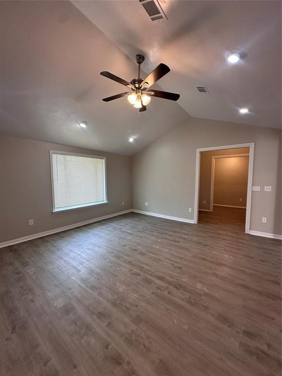 8317 NW 85th St, Oklahoma City, OK 73132 - spare room with vaulted ceiling, dark wood-style flooring, ceiling fan, and recessed lighting