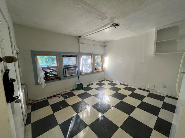 316 N University Blvd, Norman, OK 73069 - spare room with tile patterned floors, healthy amount of natural light, cooling unit, and a textured ceiling