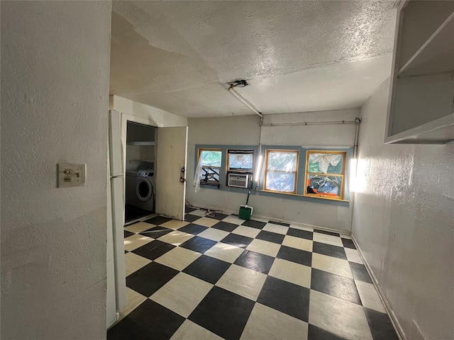316 N University Blvd, Norman, OK 73069 - spare room with tile patterned floors, a textured ceiling, a textured wall, and washer / clothes dryer
