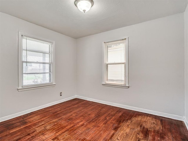 2713 S Glenn Ave, Del City, OK 73115 - spare room featuring plenty of natural light and dark wood-type flooring