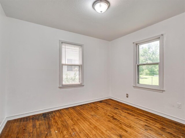 2713 S Glenn Ave, Del City, OK 73115 - spare room with baseboards and hardwood / wood-style floors