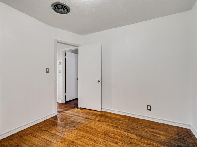 2713 S Glenn Ave, Del City, OK 73115 - empty room with wood finished floors and baseboards