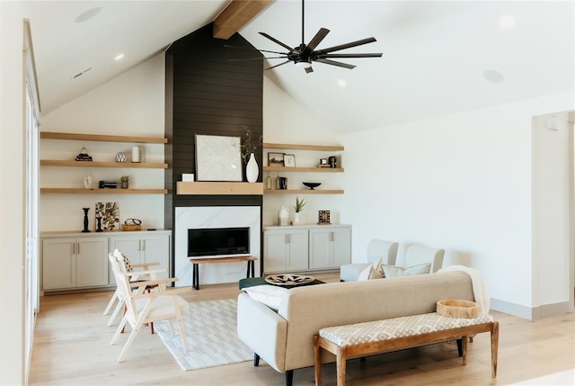 2741 Two Socks Run, Guthrie, OK 73044 - living area with a ceiling fan, light wood-style flooring, beam ceiling, a fireplace, and high vaulted ceiling