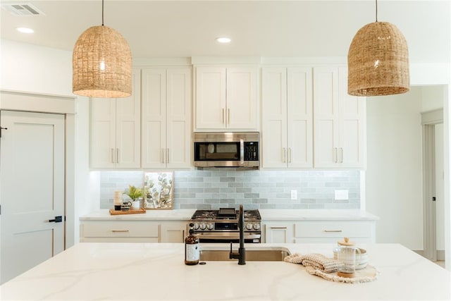 2741 Two Socks Run, Guthrie, OK 73044 - kitchen featuring stainless steel appliances, light stone counters, backsplash, white cabinetry, and recessed lighting