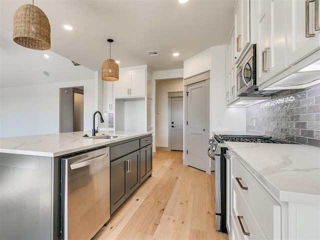 2741 Two Socks Run, Guthrie, OK 73044 - kitchen featuring stainless steel appliances, light wood-style flooring, white cabinetry, tasteful backsplash, and recessed lighting