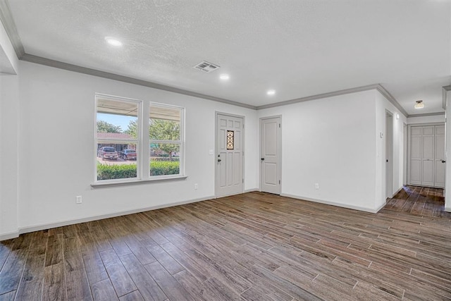 1608 Truman Dr, Altus, OK 73521 - unfurnished living room with ornamental molding, wood finished floors, and a textured ceiling