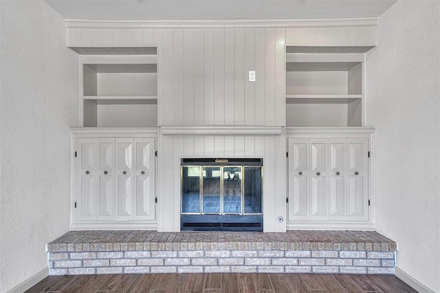1608 Truman Dr, Altus, OK 73521 - detailed view of wood finished floors, a textured wall, built in shelves, and a fireplace