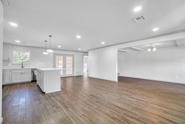 1608 Truman Dr, Altus, OK 73521 - unfurnished living room with dark wood finished floors, recessed lighting, and french doors