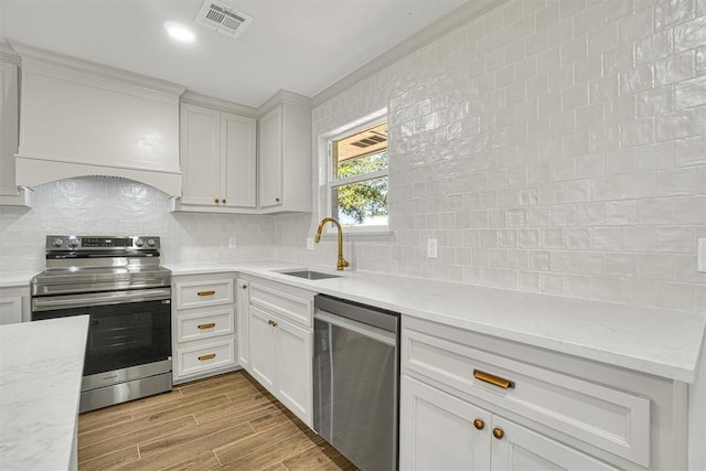 1608 Truman Dr, Altus, OK 73521 - kitchen featuring appliances with stainless steel finishes, backsplash, light wood-type flooring, and light stone countertops