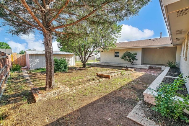 1608 Truman Dr, Altus, OK 73521 - fenced backyard featuring a garden and a shed