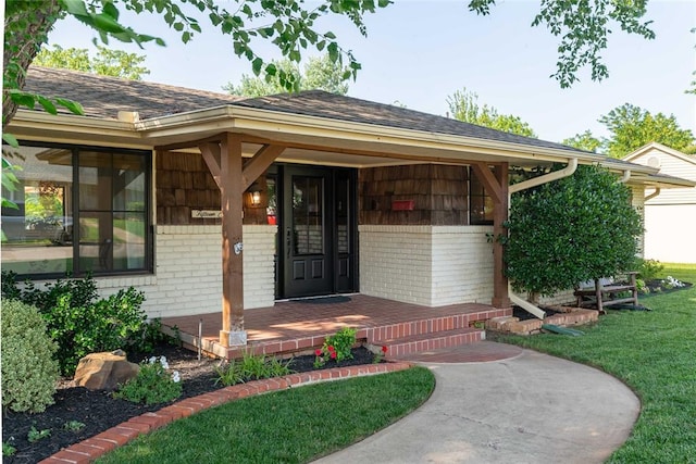 1503 Brighton Ave, Oklahoma City, OK 73120 - view of exterior entry with brick siding, a shingled roof, a yard, and a porch
