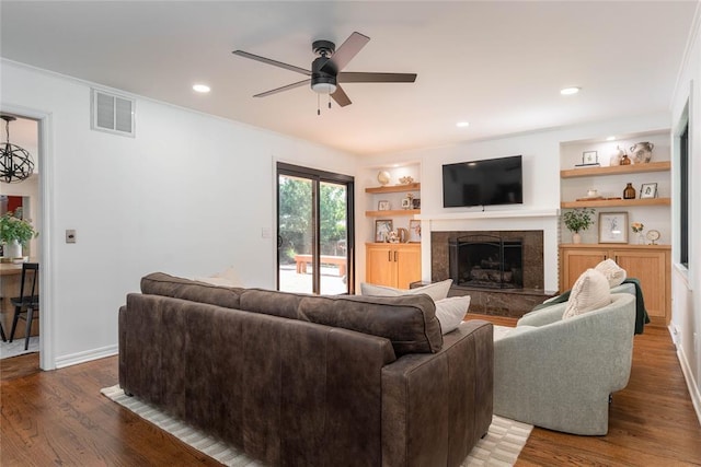 1503 Brighton Ave, Oklahoma City, OK 73120 - living room featuring ceiling fan, a high end fireplace, wood finished floors, built in shelves, and ornamental molding