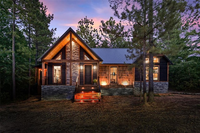 42 Hickory Ridge Rd, Broken Bow, OK 74728 - view of front of house featuring stone siding, a porch, and a metal roof