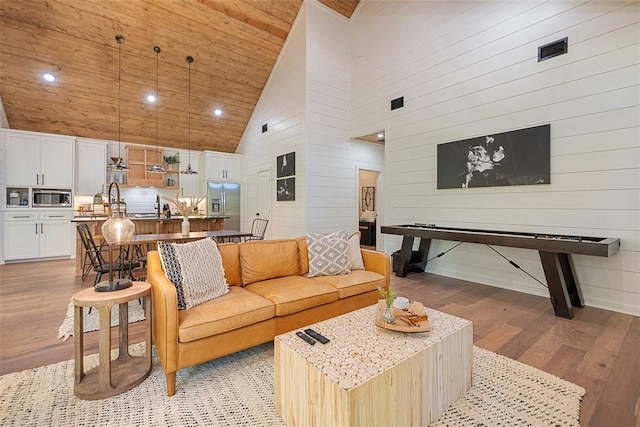 42 Hickory Ridge Rd, Broken Bow, OK 74728 - living area featuring light wood-style flooring, high vaulted ceiling, wood ceiling, wood walls, and recessed lighting