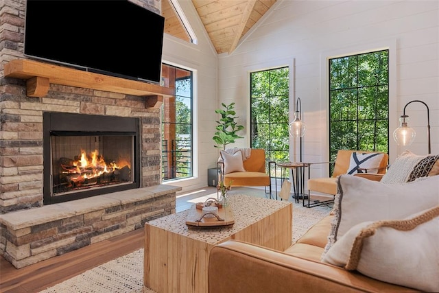 42 Hickory Ridge Rd, Broken Bow, OK 74728 - living room featuring wood ceiling, vaulted ceiling, healthy amount of natural light, a fireplace, and wood finished floors