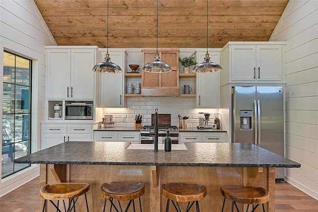 42 Hickory Ridge Rd, Broken Bow, OK 74728 - kitchen featuring vaulted ceiling, wood ceiling, open shelves, stainless steel appliances, and dark wood-style floors