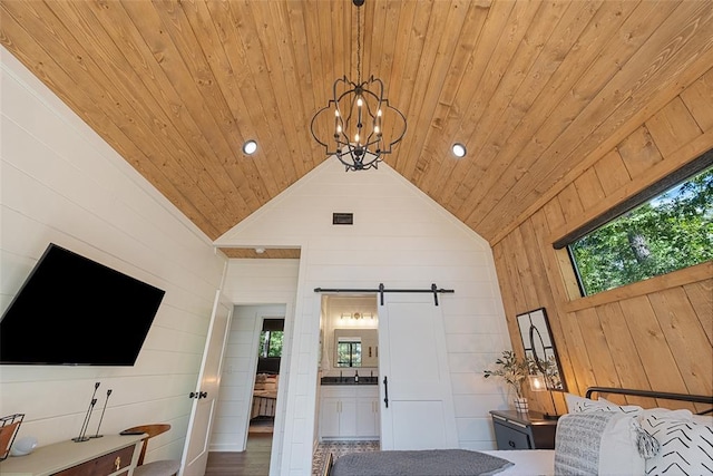 42 Hickory Ridge Rd, Broken Bow, OK 74728 - living area with wooden ceiling, a barn door, wooden walls, a chandelier, and lofted ceiling